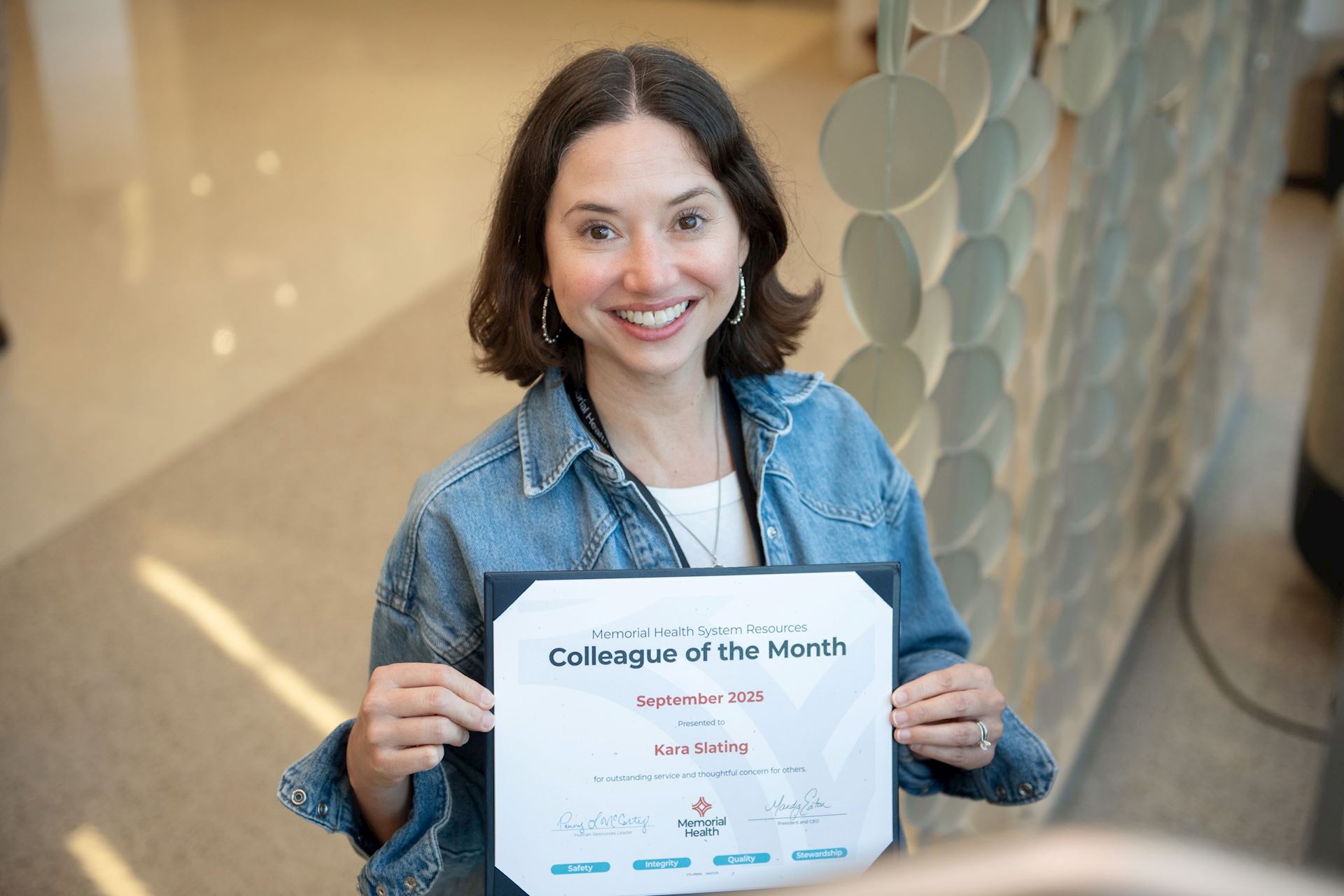 Image of a colleague being recognized with an award.